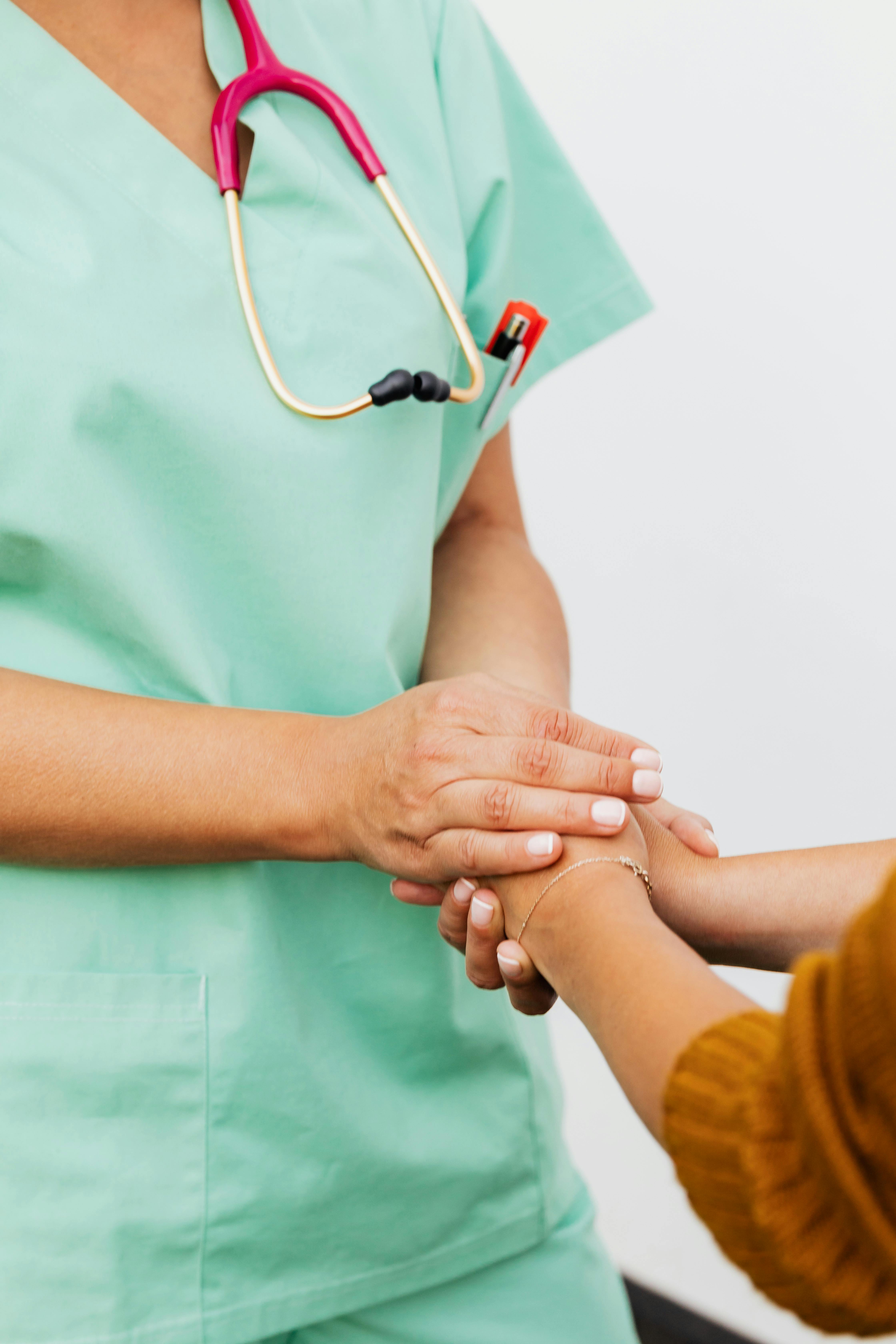 Optometrist holding hands with a patient